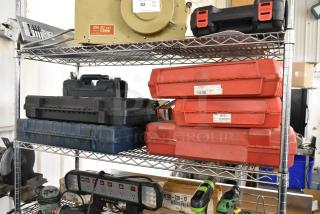 Set of 7 tool boxes on metal shelves, includes Hilti drill, Hilti reciprocating saw, DeWalt saw, Bosch jigsaw, Bosch rotary hammer, Skil grinder.
