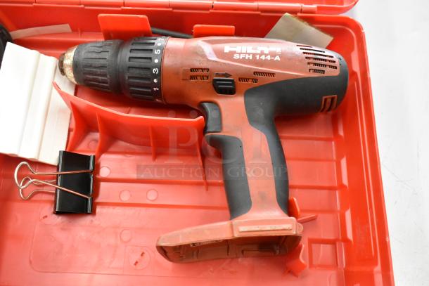 Hilti SFH144-A drill in a red tool box, visible wear, key features include adjustable settings, ideal for heavy-duty tasks.