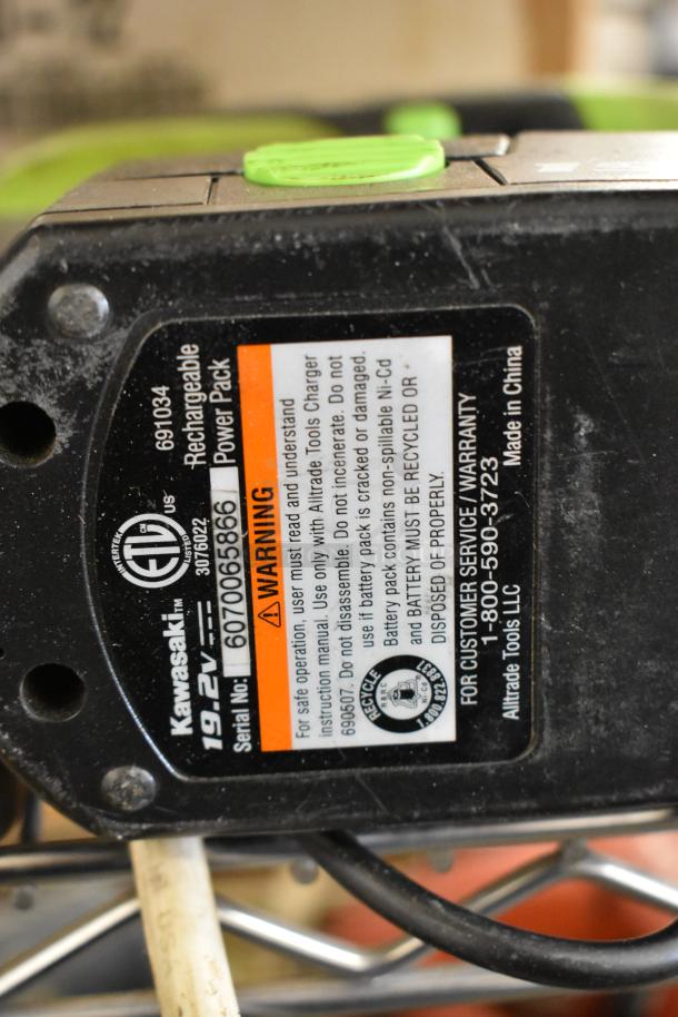 Kawasaki 19.2V Rechargeable Power Pack, serial number 607006586, with warning label and contact info for Alltrade Tools LLC.