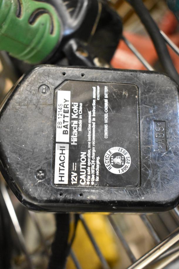 Hitachi 12V EB 1214S battery with caution label, showing wear, included in auction lot of 9 various tools.
