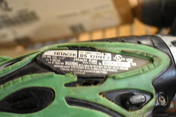 Hitachi DS12DVF3 cordless driver drill, green and black, 12V, with visible branding and specifications on the label.