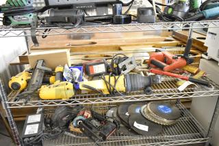 Assorted tools on shelves: DeWalt DW304 saw, DeWalt D51431 stapler, Bosch 1590EVS sander, Hilti TE4-A18, and more.