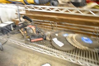 Blurred image showing a Craftsman scroller saw, various saw blades, and an Alfa transformer on a shelf. Items appear used.