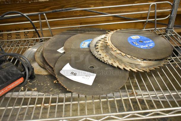 Assorted saw blades and tools, including Craftsman scroller saw, Alfa transformer on metal shelf. Auction tag 86, lot of 17 items.