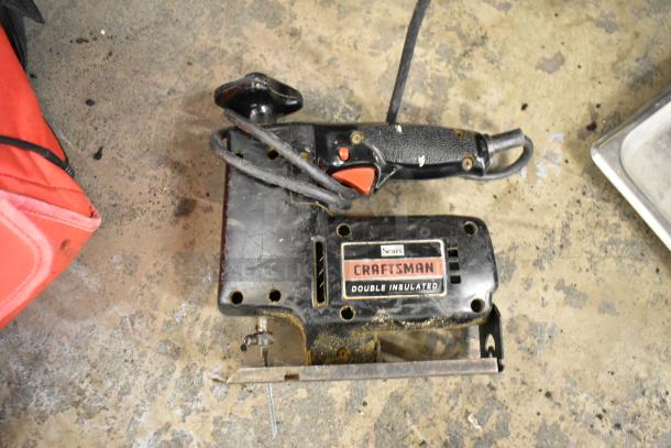 Craftsman double insulated scroller saw, used condition. Features black and red handle, visible Sears label.