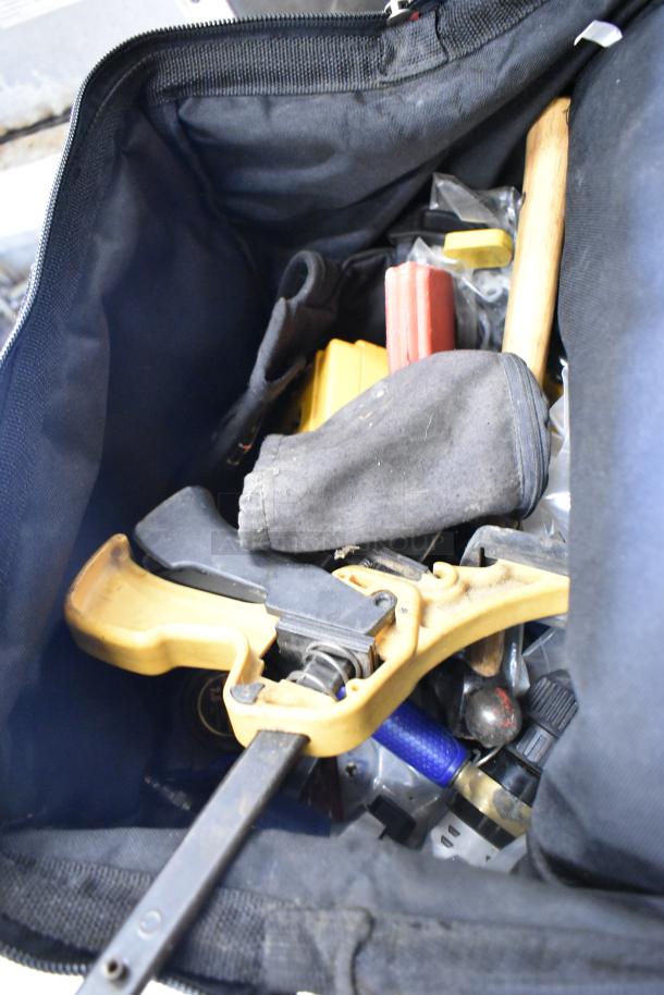 Hilti tool bag with assorted tools, including clamps. Bag shows light wear. Various tool handles and pouches visible inside.