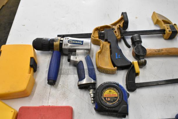 Hilti tool bag contents, including Kobalt drill, clamps, hammer, measuring tape. Gently used, various brands visible.