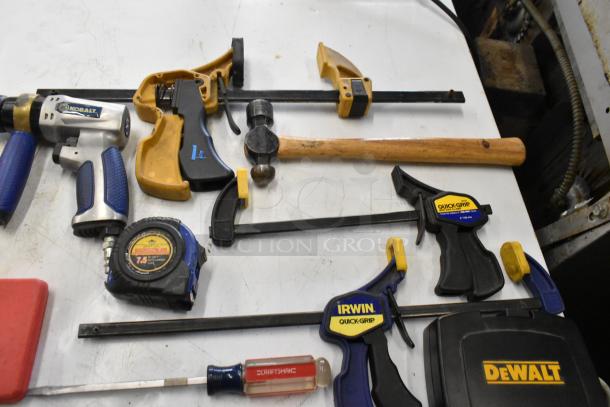 Hilti tool bag contents: Kobalt air drill, Irwin Quick-Grip clamps, Craftsman screwdriver, measuring tape, and hammer.