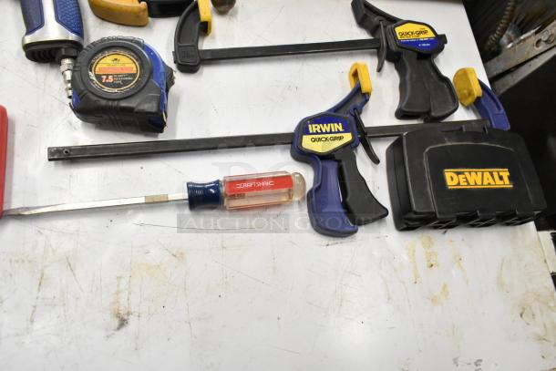 Hilti tool bag contents: Irwin Quick-Grip clamps, Craftsman screwdriver, DeWalt box, measuring tape. Lightly used.
