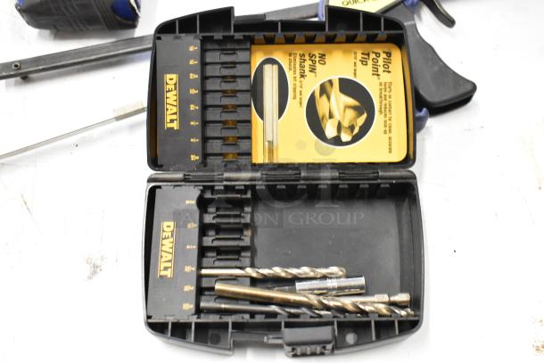 Hilti tool bag containing DeWalt drill bits set, various clamps; shows signs of use.