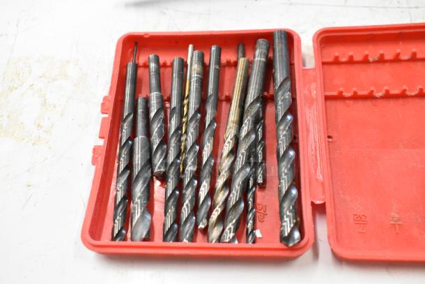 Red Hilti tool case with assorted metal drill bits in good condition.