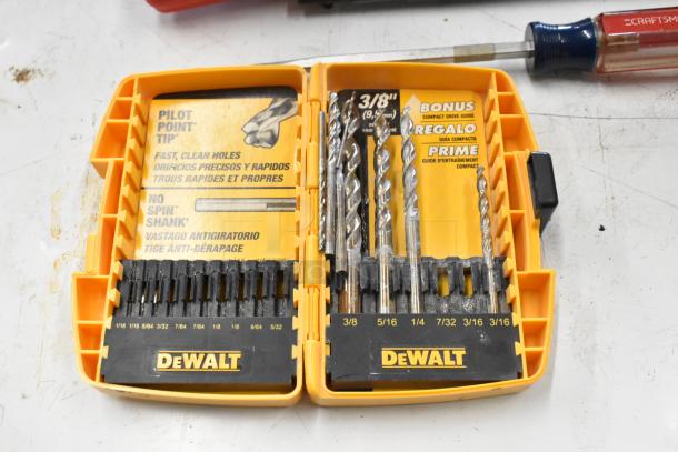 DeWalt drill bit set with "Pilot Point Tip" and "No Spin Shank" features in an orange case, includes various sizes.