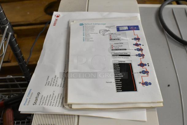 Two Xerox Phaser 7500 printers with manuals, showing setup instructions and language options. Excellent condition.