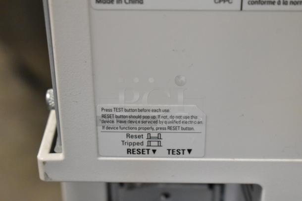 Close-up of a label on a Xerox Phaser 7500 printer. It instructs on using the test and reset buttons for functionality checks.
