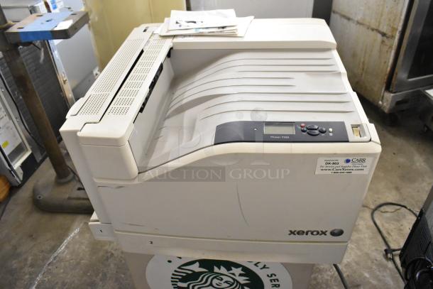 Two Xerox Phaser 7500 printers, slightly used, with visible labeling. Ideal for high-volume printing tasks.