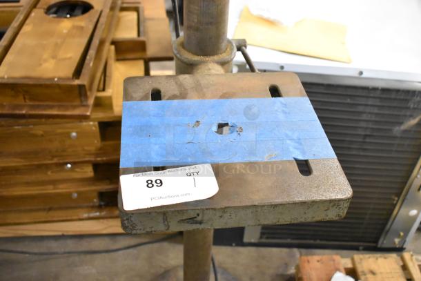 Delta/Milwaukee unit, 120V, 1-phase, worn condition, metal table with blue tape and auction tag labeled "89 QTY 1."