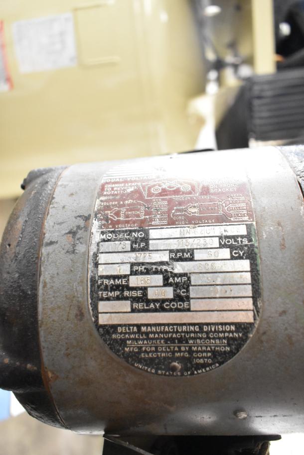 Delta/Milwaukee unit, 1/3 HP, 115/230V, 1 Phase, 1725 RPM, steel casing, Delta Manufacturing Division label, worn condition.
