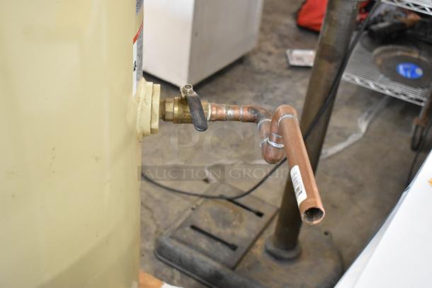 Ingersoll Rand 2475N5-V commercial air compressor with visible copper piping connection, beige metal exterior, good condition.