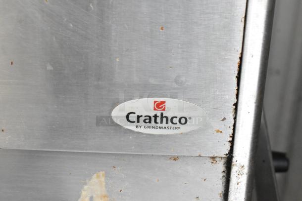 Crathco D25-3 stainless steel beverage machine base, visible branding "Crathco by Grindmaster," some surface wear.