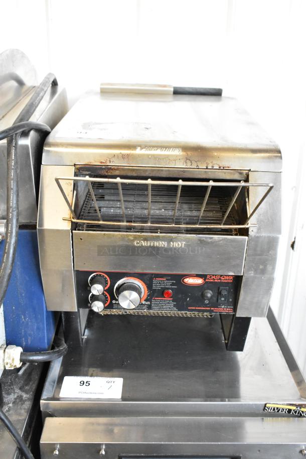 Hatco TQ-800HBA stainless steel commercial countertop conveyor toaster oven, 208 volts, 1 phase, with visible control knobs and "Caution Hot" label.