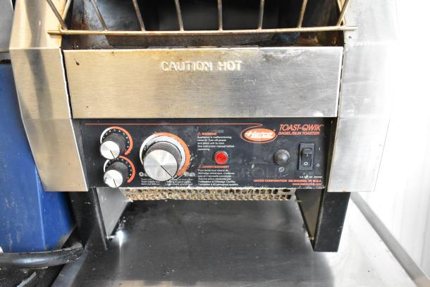 Hatco TQ-800HBA Stainless Steel Conveyor Toaster Oven, 208 Volts, 1 Phase. Features adjustment knobs, caution label.