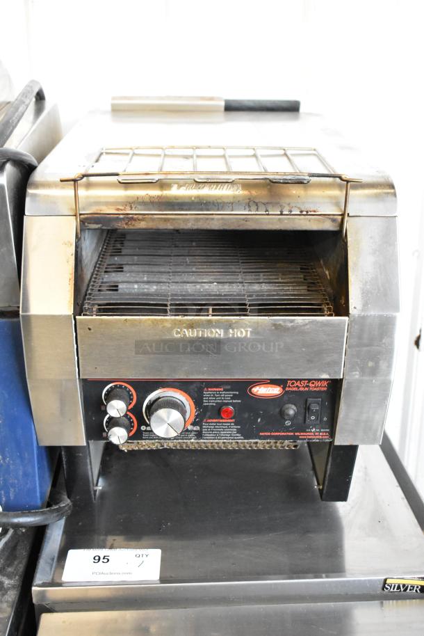 Hatco TQ-800HBA stainless steel commercial conveyor toaster oven, 208V, 1 Phase. Shows wear; control knobs and "Caution Hot" label visible.