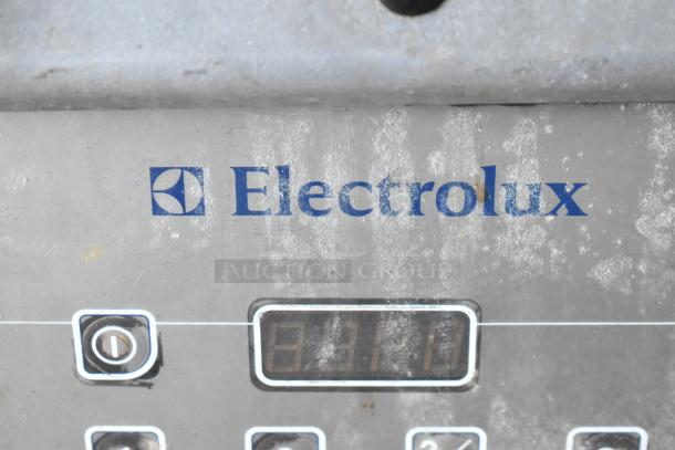 Electrolux HSPPAN commercial countertop panini press. Metal body, 208V, 1 phase. Visible wear, Electrolux logo displayed.
