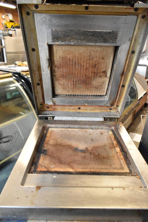 Electrolux HSPPAN Metal Commercial Panini Press, 208 Volts, 1 Phase. Visible wear and grease on cooking surfaces.