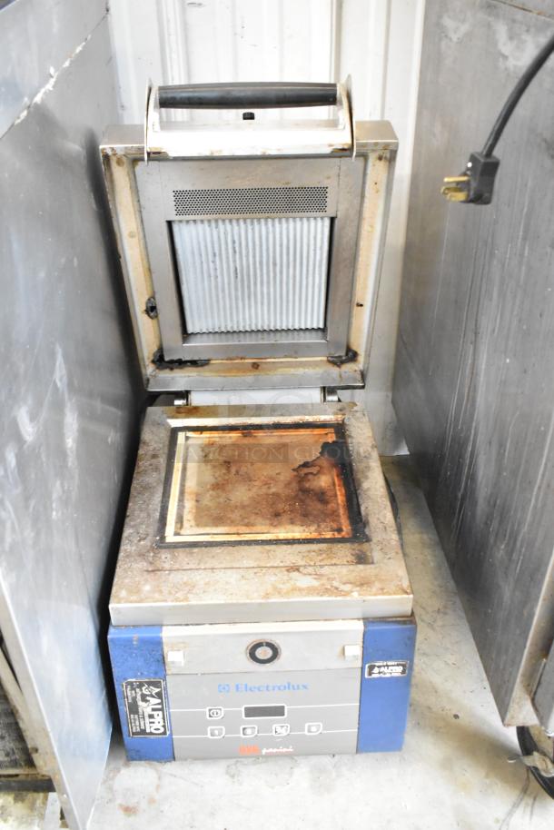 Electrolux HSPPAN metal panini press, commercial countertop model, visible wear and residue, 208 volts, 1 phase, Electrolux branding.