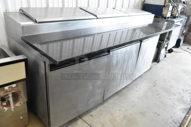Delfield 18699PTT stainless steel pizza prep table with cutting board, commercial casters, 115V, 1 phase.