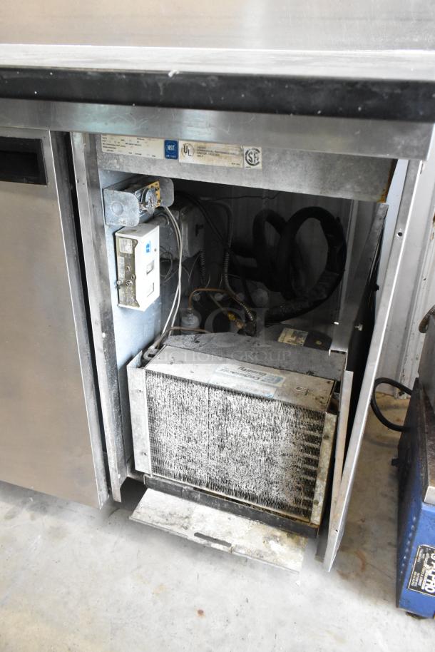 Delfield 18699PTT stainless steel pizza prep table with cutting board, commercial casters, 115V, 1 phase, internal view.