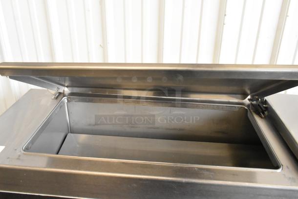 Delfield 18699PTT stainless steel pizza prep table with cutting board and commercial casters. 115V, 1 phase.