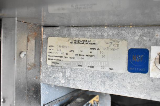 Delfield 18699PTT Pizza Prep Table label, showing model, 115 volts, serial number 1283106-T, and NSF certification.