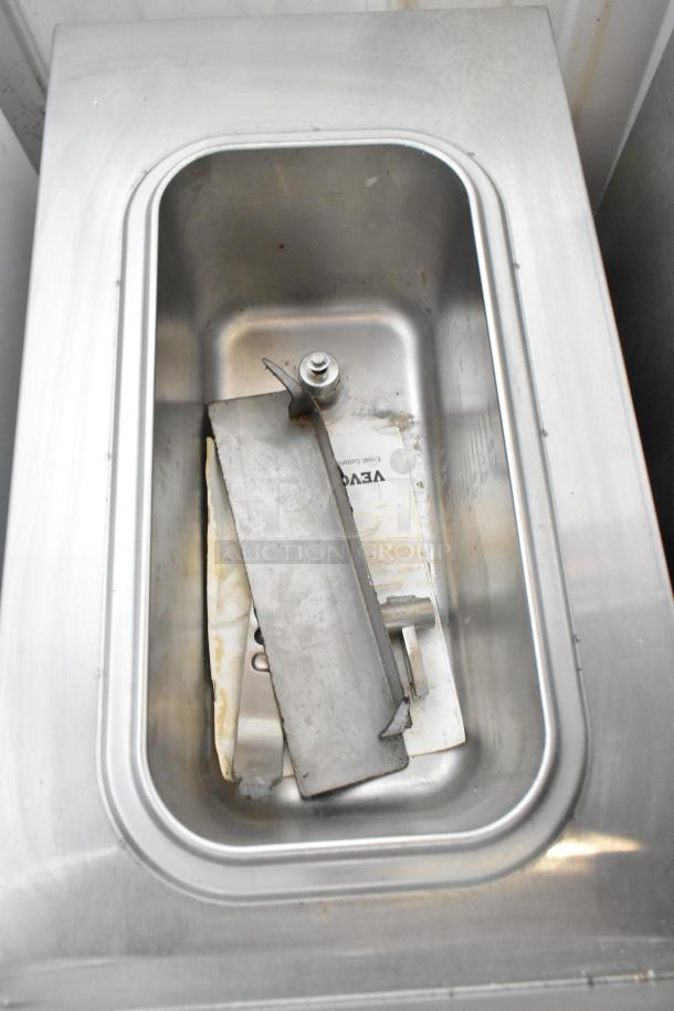 Vevor XRJF-11 stainless steel slushie machine interior. Visible mixing paddle, lightly worn, fits commercial countertop. 115V, 1 phase.