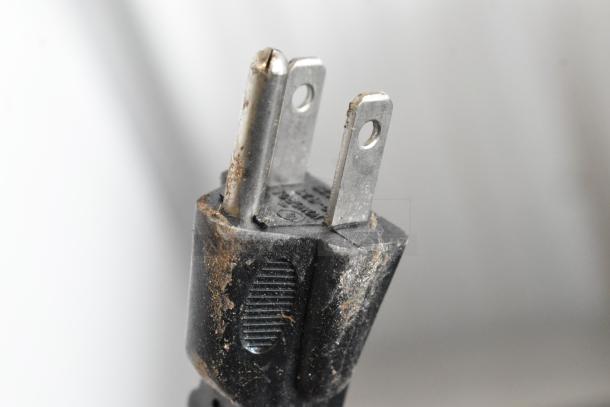 Close-up of a worn power plug from the Vevor XRJF-11 Slushie Machine, showing signs of wear and dust accumulation.