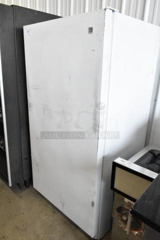 Maytag MQU2057AEW single door reach-in freezer, 115 volts, showing surface wear, auction tag visible.
