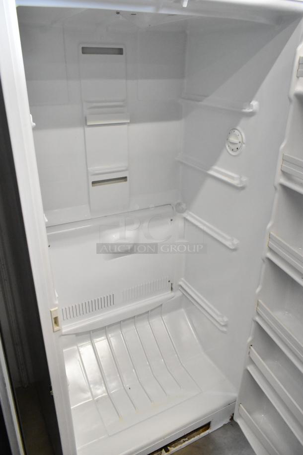 Maytag MQU2057AEW single door reach-in freezer, interior view, 115 volts, 1 phase, showing shelves and thermostat.