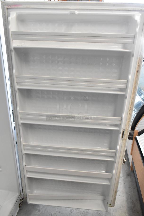 Maytag MQU2057AEW reach-in freezer, single door, 115V, 1 phase, shelves visible, appears in good condition.