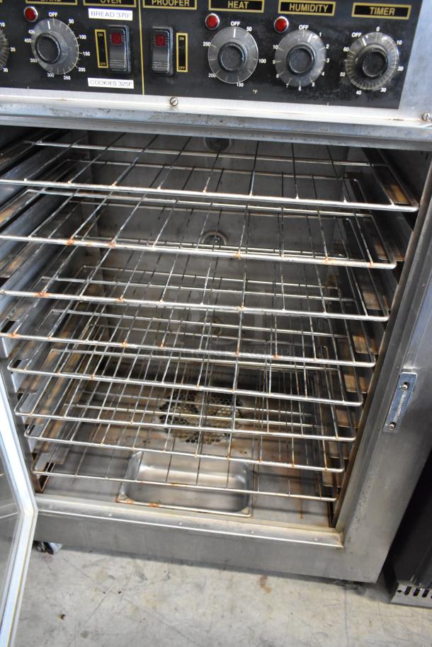 Nu Vu SUB-123 stainless steel commercial oven proofer with racks, dials for temperature and humidity, and visible wear.