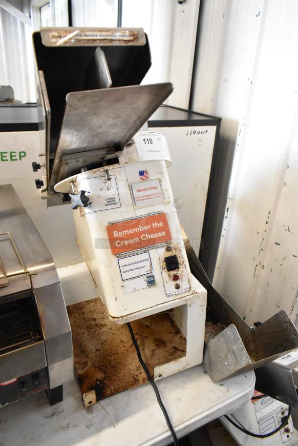 Oliver 702-N metal commercial countertop bagel slicer, 115 volts, 1 phase, visible wear, "Remember the Cream Cheese" label.