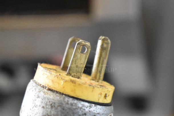 Close-up of a worn metal plug from an Oliver 702-N Commercial Bagel Slicer. The plug shows signs of use.