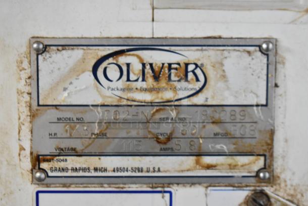 Oliver 702-N Metal Commercial Bagel Slicer. 115 Volts, 1 Phase. Visible label with specifications and notable wear.