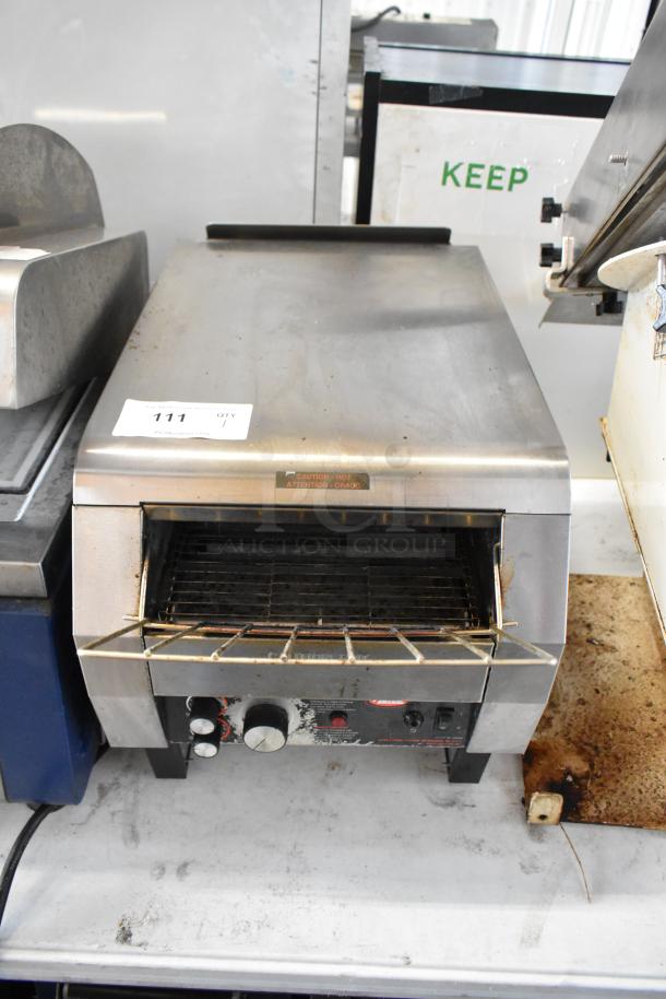 Hatco TQ-800HBA stainless steel commercial conveyor toaster oven in used condition, 208 volts, 1 phase; features visible dials.