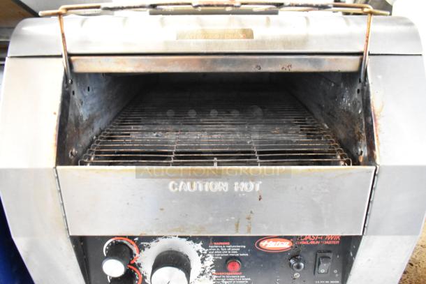 Hatco TQ-800HBA commercial conveyor toaster oven, stainless steel, 208V, 1 phase, visible wear, "Caution Hot" labeled.