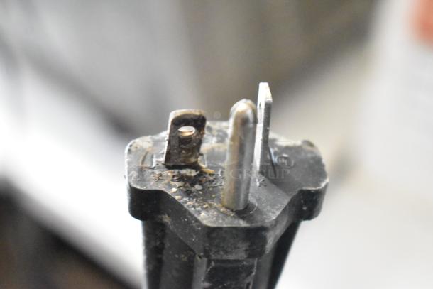 Close-up of a power plug from the Hatco TQ-800HBA conveyor toaster oven. The plug shows signs of wear.