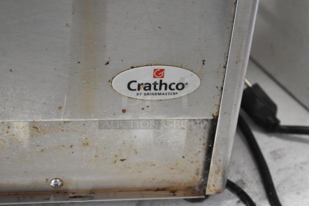 Crathco stainless steel 2-hopper beverage machine base, 115 volts, 1 phase, noticeable wear, Crathco logo visible.