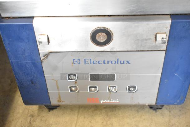 Electrolux HSPPAN metal commercial countertop panini press, 208 volts, 1 phase. Visible wear and control panel with buttons.