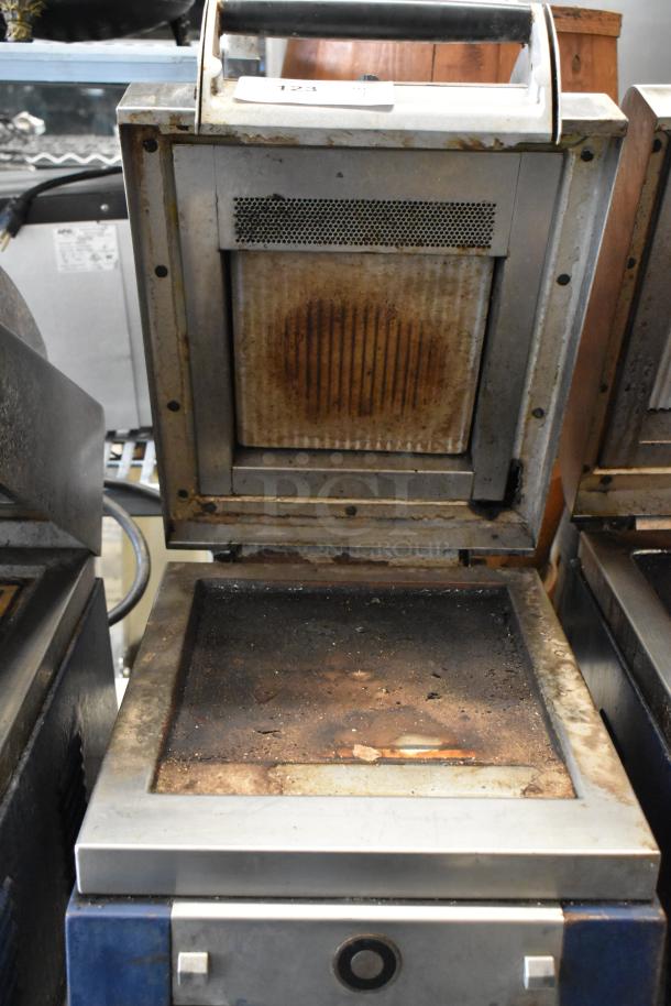 Electrolux HSPPAN metal commercial panini press, used condition, 208 volts, 1 phase, visible wear and discoloration.