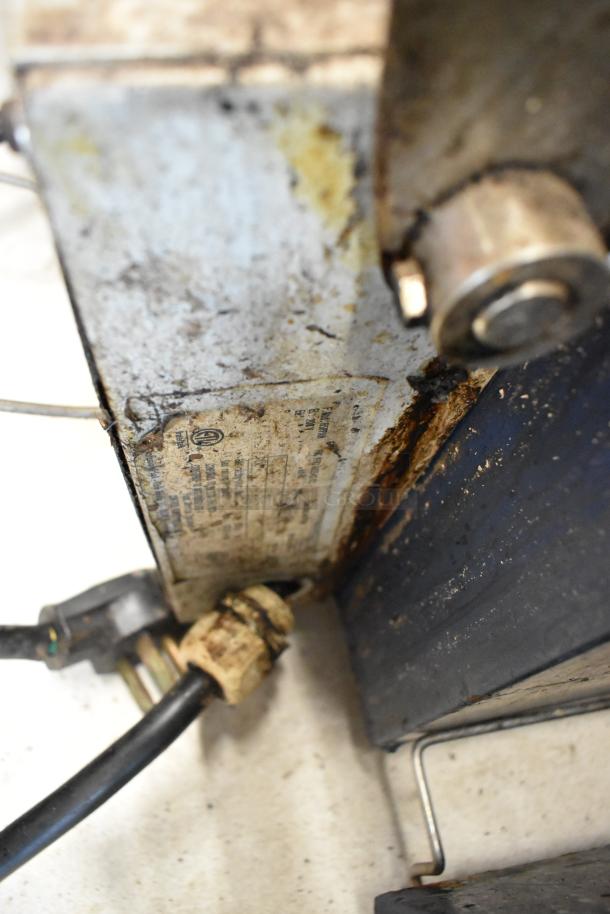 Electrolux HSPPAN commercial panini press, metal casing, 208V, 1 phase, visible wear and rust on metal surface.