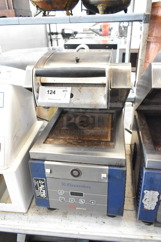 Electrolux HSPPAN metal commercial countertop panini press, 208 volts, 1 phase. Visible wear, Electrolux branding, model label intact.